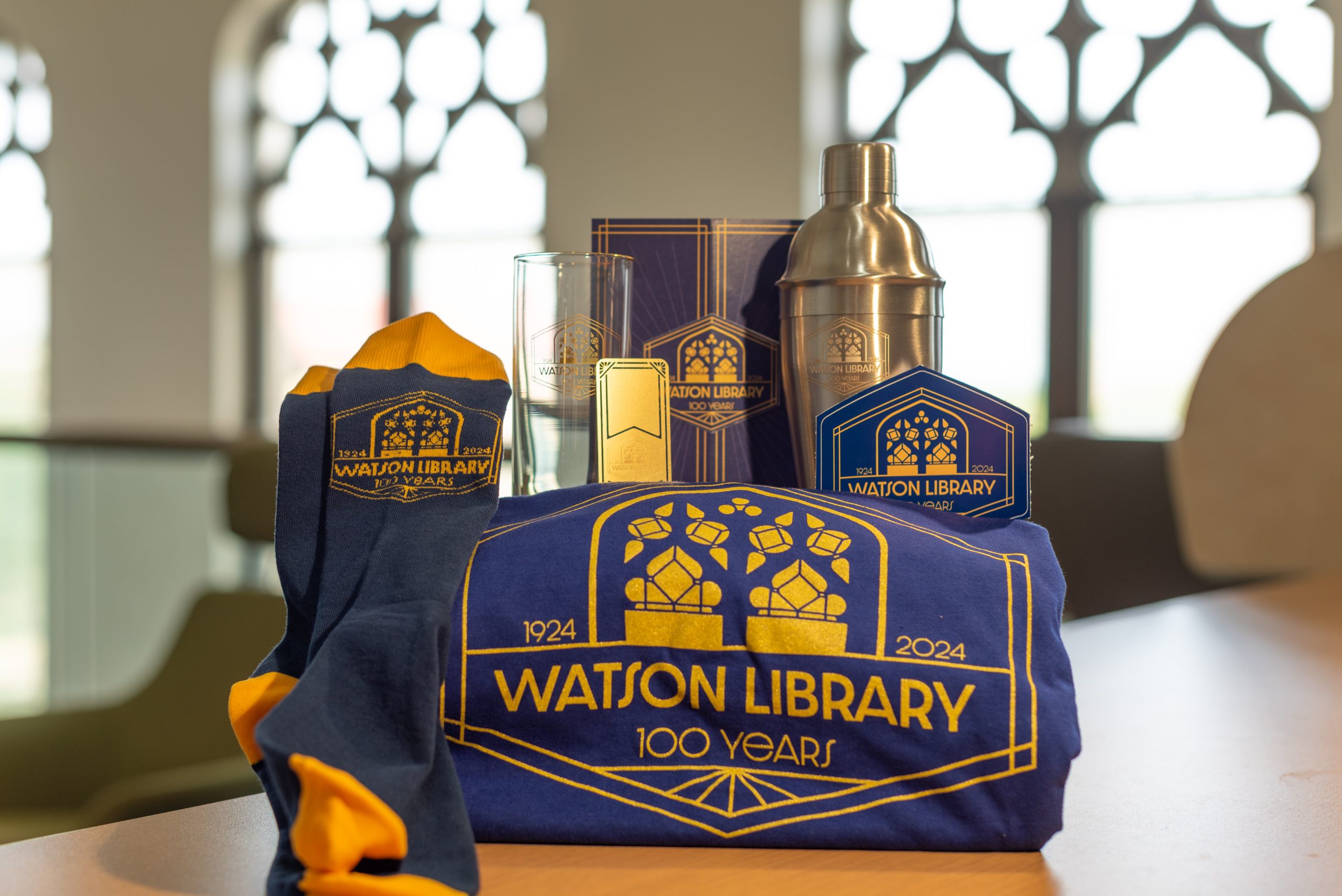 Watson Library centennial-branded items artfully arranged